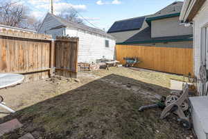 View of yard with a fenced backyard and an outdoor structure