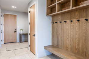 Mudroom with tile patterned flooring and baseboards