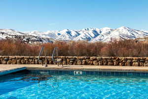 View of swimming pool with a mountain view