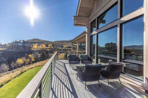 Wooden deck featuring a mountain view and an outdoor living space