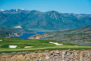 View of mountain feature featuring golf course view and a water view