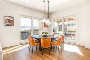 Dining room with light wood-type flooring, a mountain view, and baseboards