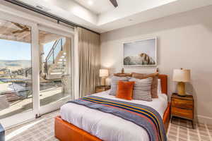 Carpeted bedroom featuring access to exterior, baseboards, and visible vents