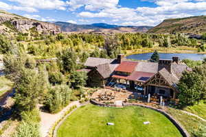 Birds eye view of property featuring a water and mountain view