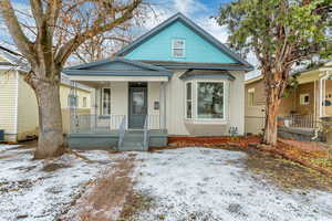 View of front of house with covered porch and stucco siding