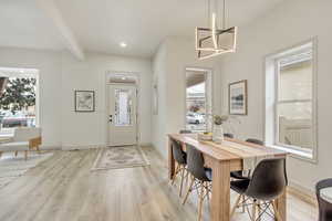 Foyer featuring light wood-style floors, plenty of natural light, and baseboards