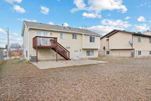 Rear view of house with central air condition unit, a patio area, fence, and stairway