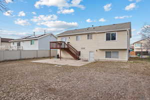 Back of house with a fenced backyard, stairs, central AC, and a patio