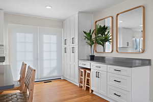 Interior space featuring recessed lighting, visible vents, and light wood finished floors