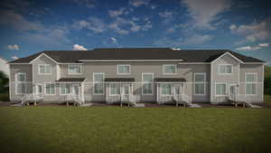 Rear view of house featuring a lawn