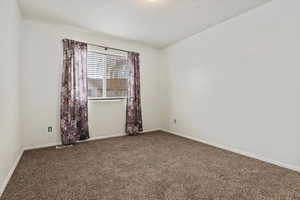 Spare room with carpet floors and baseboards