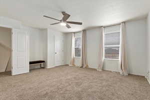 Unfurnished bedroom featuring carpet floors, visible vents, ceiling fan, and baseboards