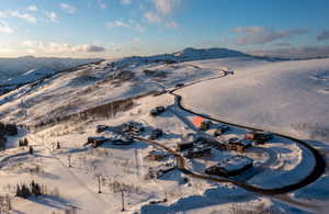 Snowy aerial view featuring a mountain view