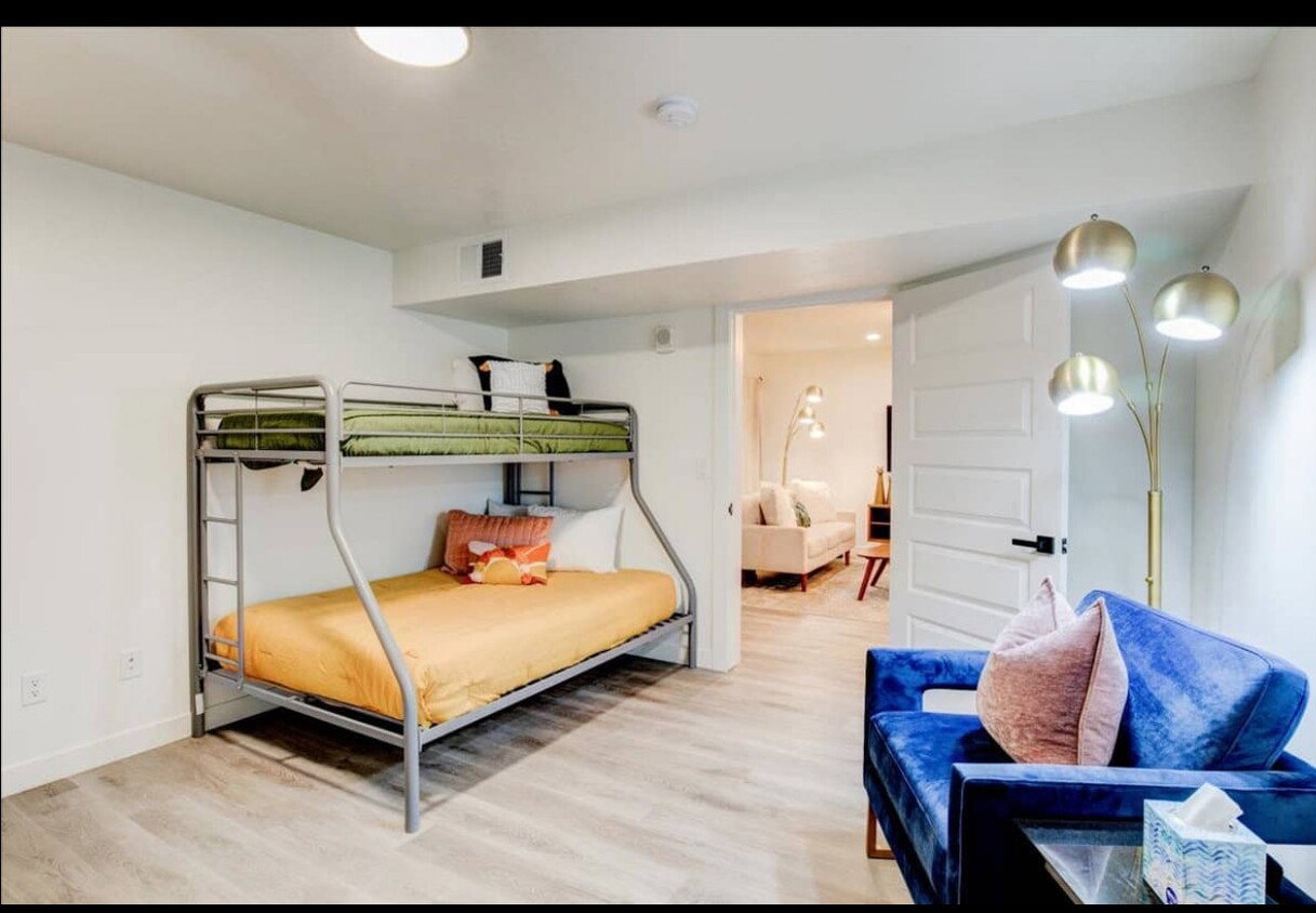 Bedroom featuring visible vents, light wood-style flooring, and baseboards