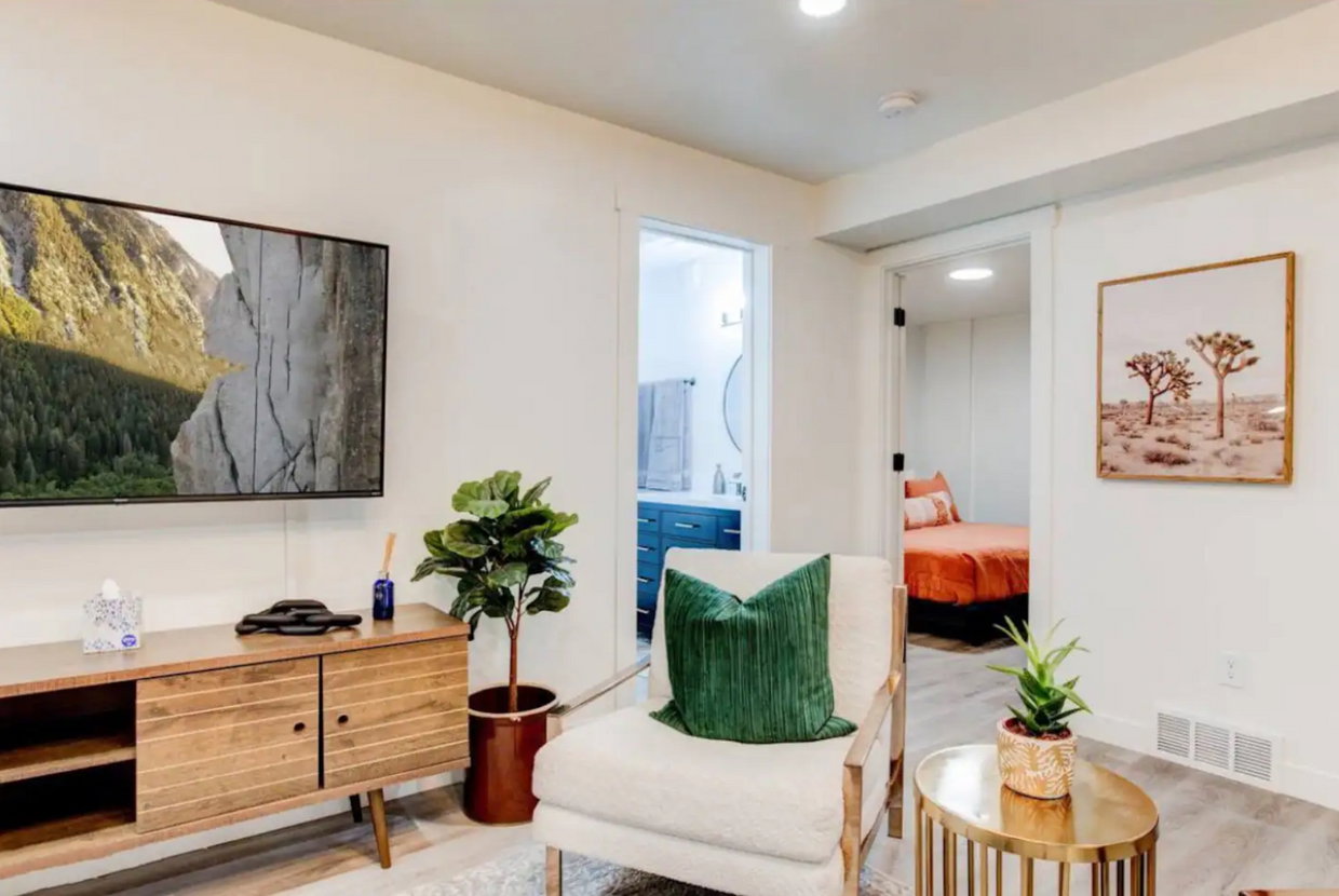 Sitting room with light wood-type flooring, baseboards, and visible vents