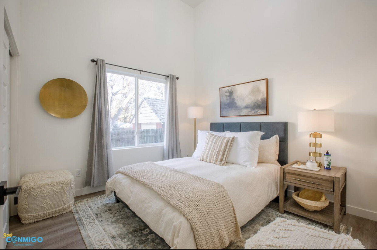 Bedroom featuring a high ceiling, wood finished floors, and baseboards