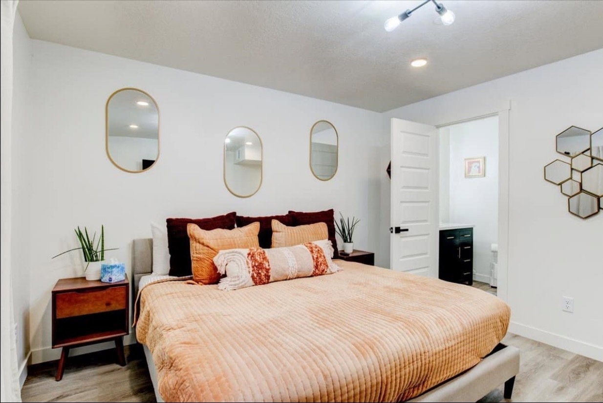 Bedroom with light wood-style floors and baseboards