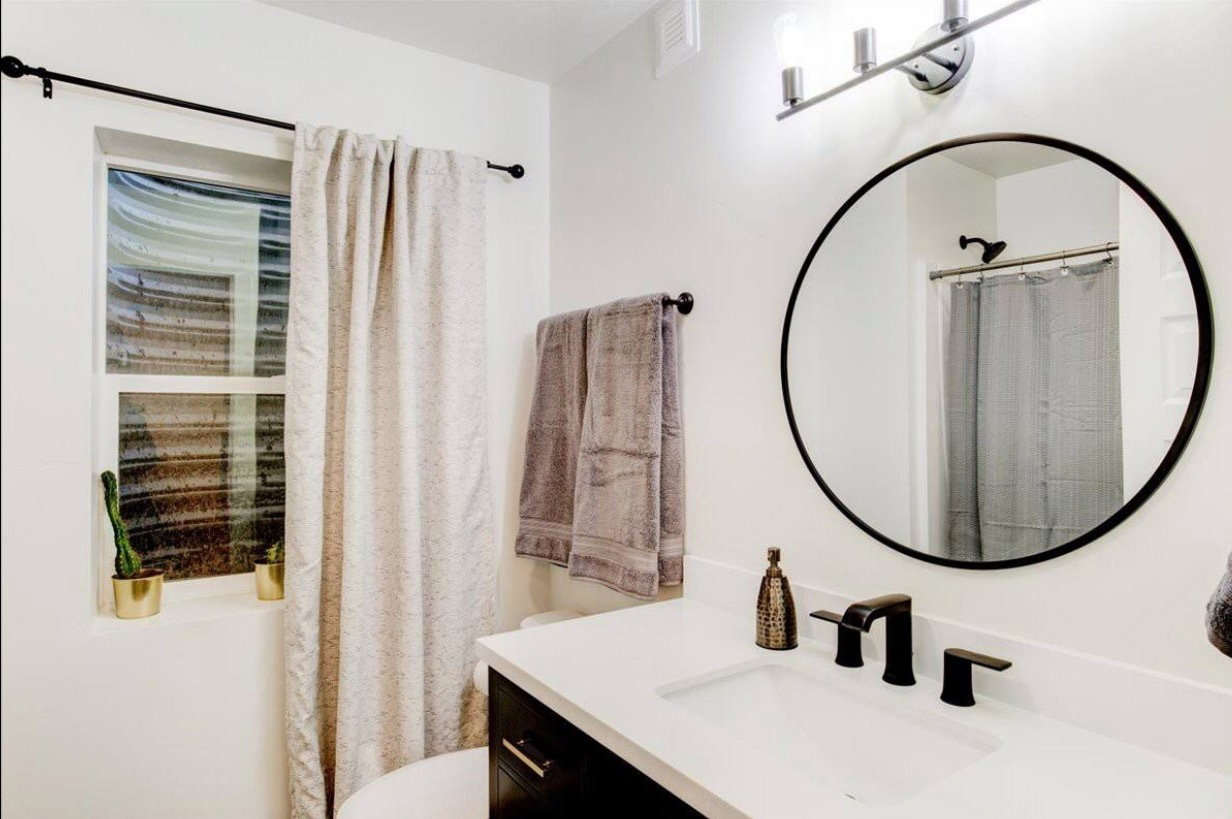 Bathroom with a shower with shower curtain, vanity, and toilet