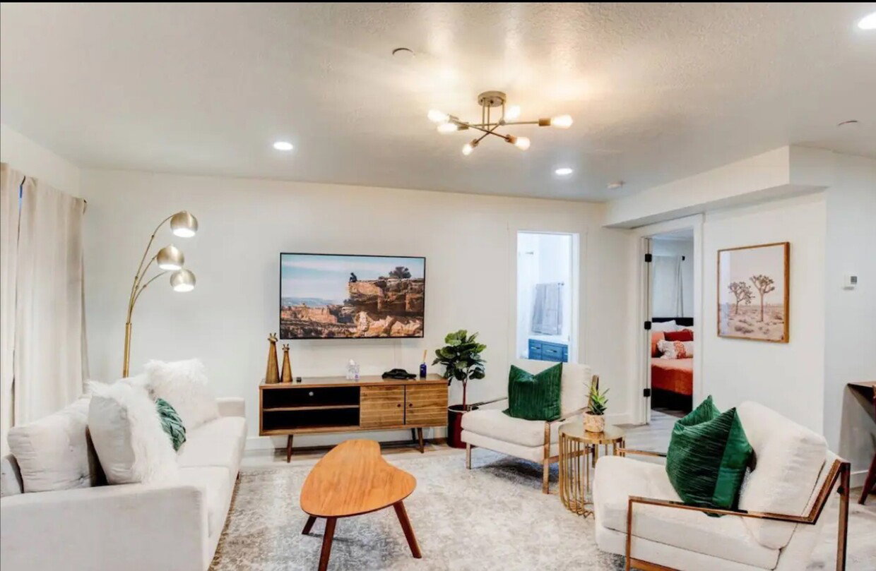 Living room with recessed lighting and a notable chandelier
