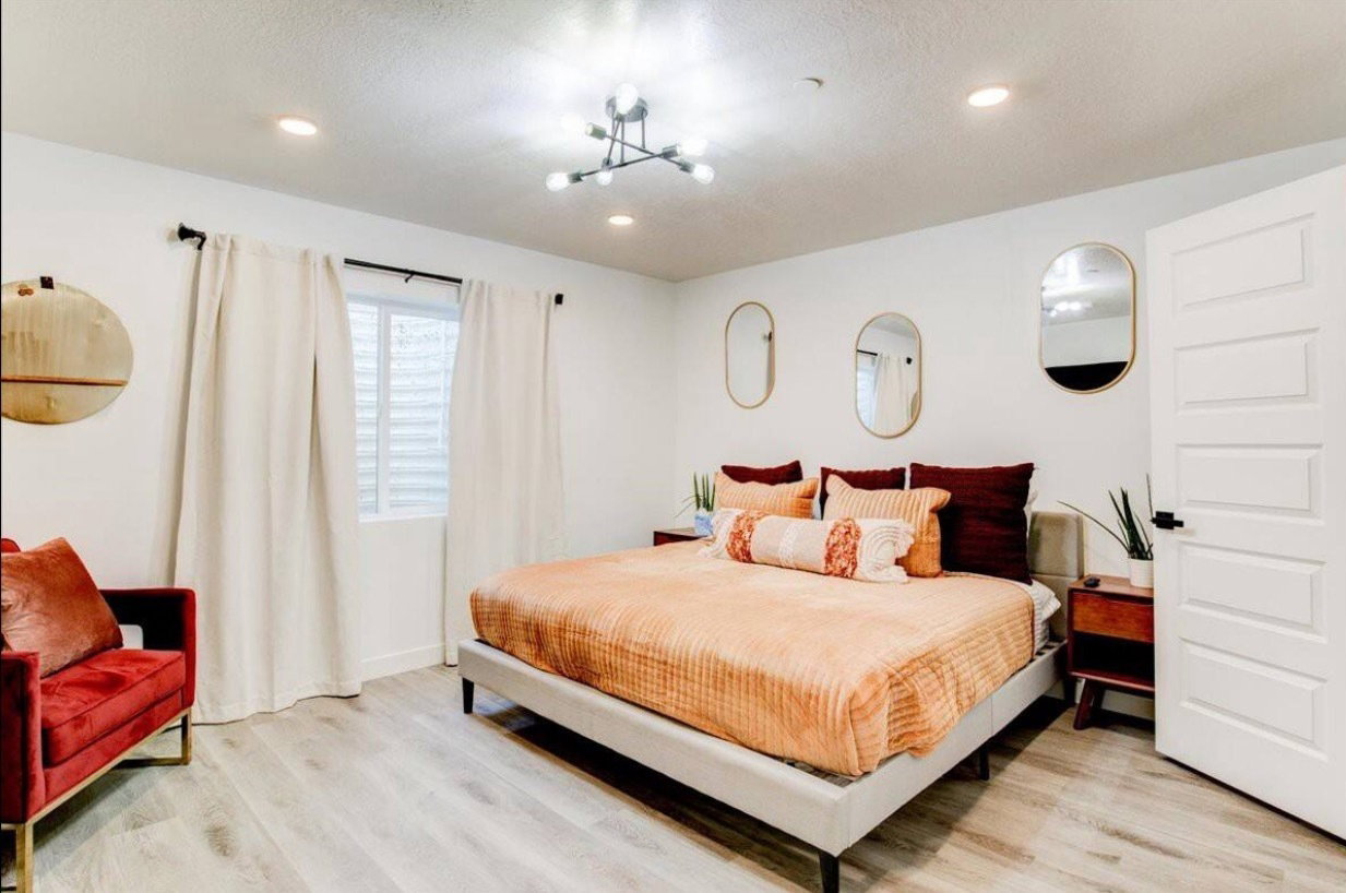 Bedroom featuring a chandelier, a textured ceiling, light wood-style flooring, and recessed lighting