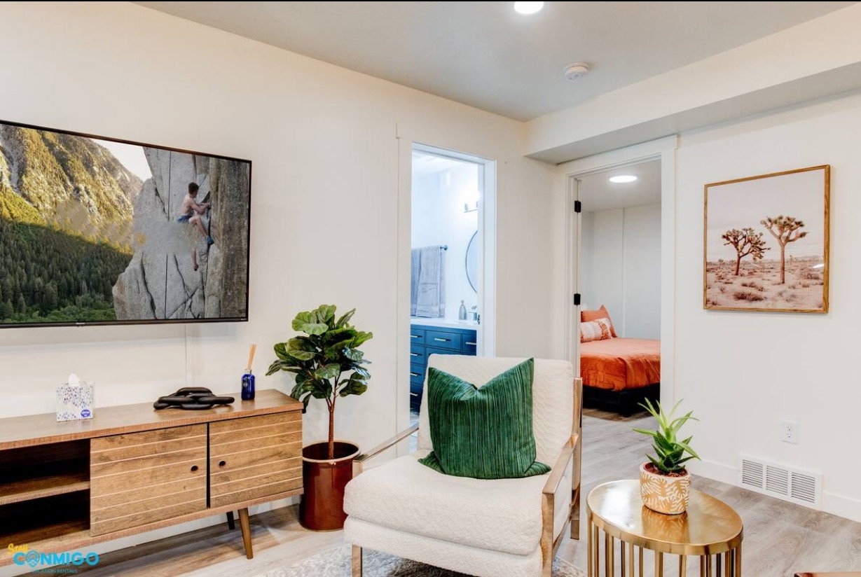 Living area with light wood finished floors, baseboards, and visible vents