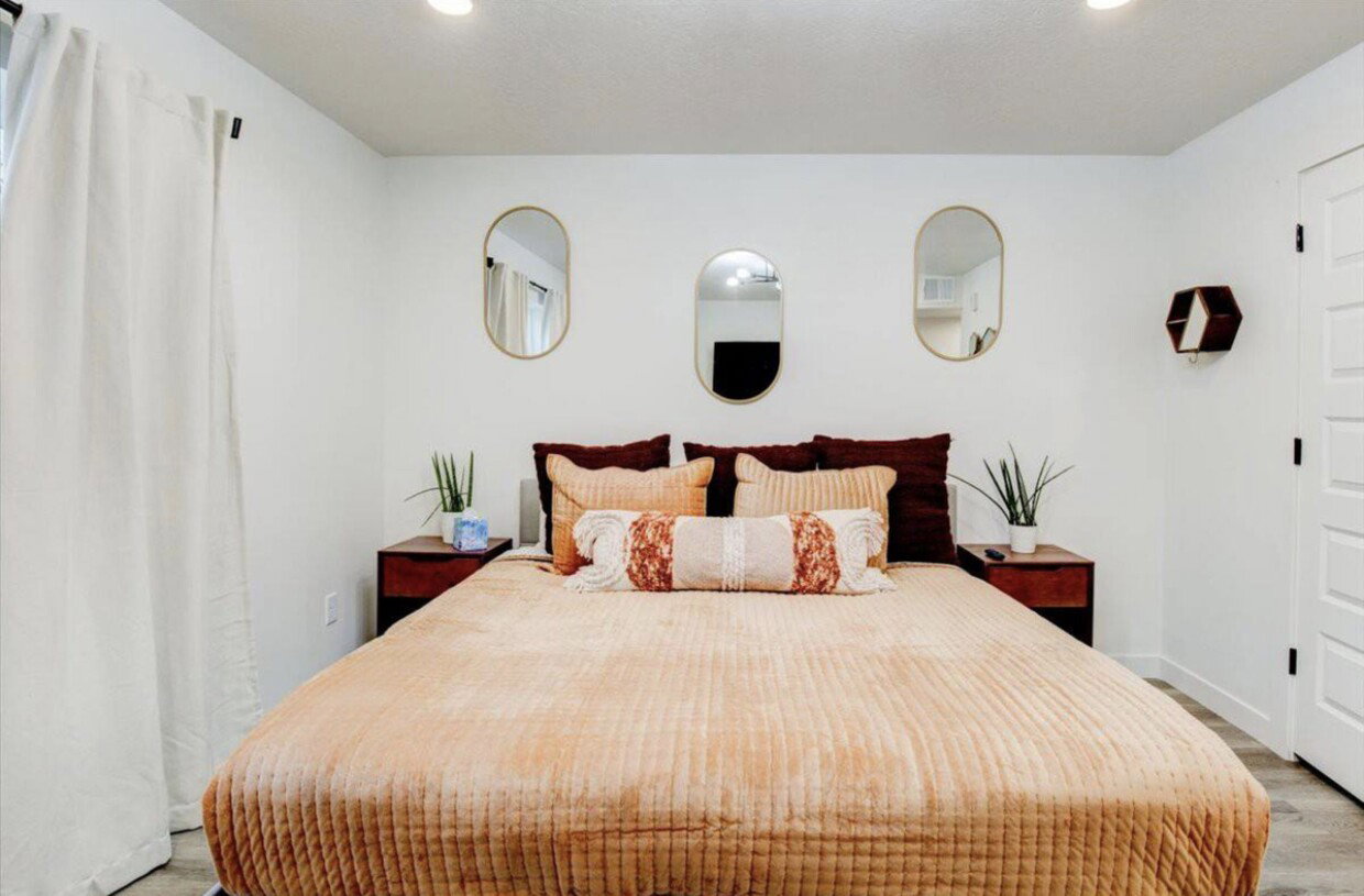Bedroom featuring light wood finished floors, baseboards, and recessed lighting