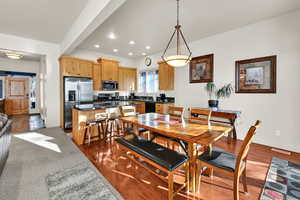 Dining area with recessed lighting and dark wood finished floors