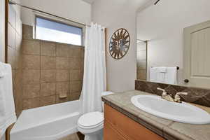 Bathroom featuring shower / bath combo and vanity