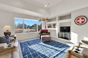 Carpeted living room featuring baseboards and recessed lighting
