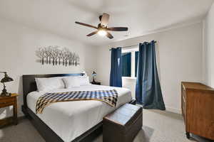 Bedroom with a ceiling fan and carpet floors