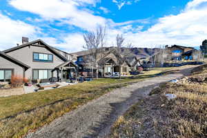 Rear view of house with a patio and a yard