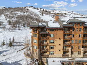 Snow covered building featuring a mountain view