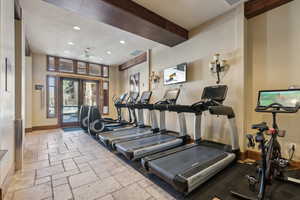 Workout area with visible vents, baseboards, stone tile flooring, french doors, and recessed lighting