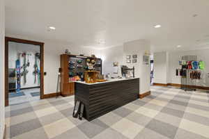 Home office with baseboards, a dry bar, and recessed lighting