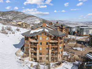 Snow covered building with a mountain view