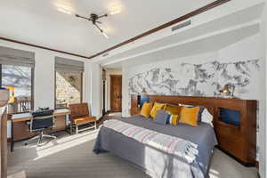 Carpeted bedroom featuring visible vents and crown molding