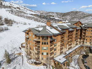 Snowy aerial view featuring a mountain view