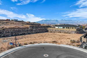 View of yard featuring fence and a mountain view