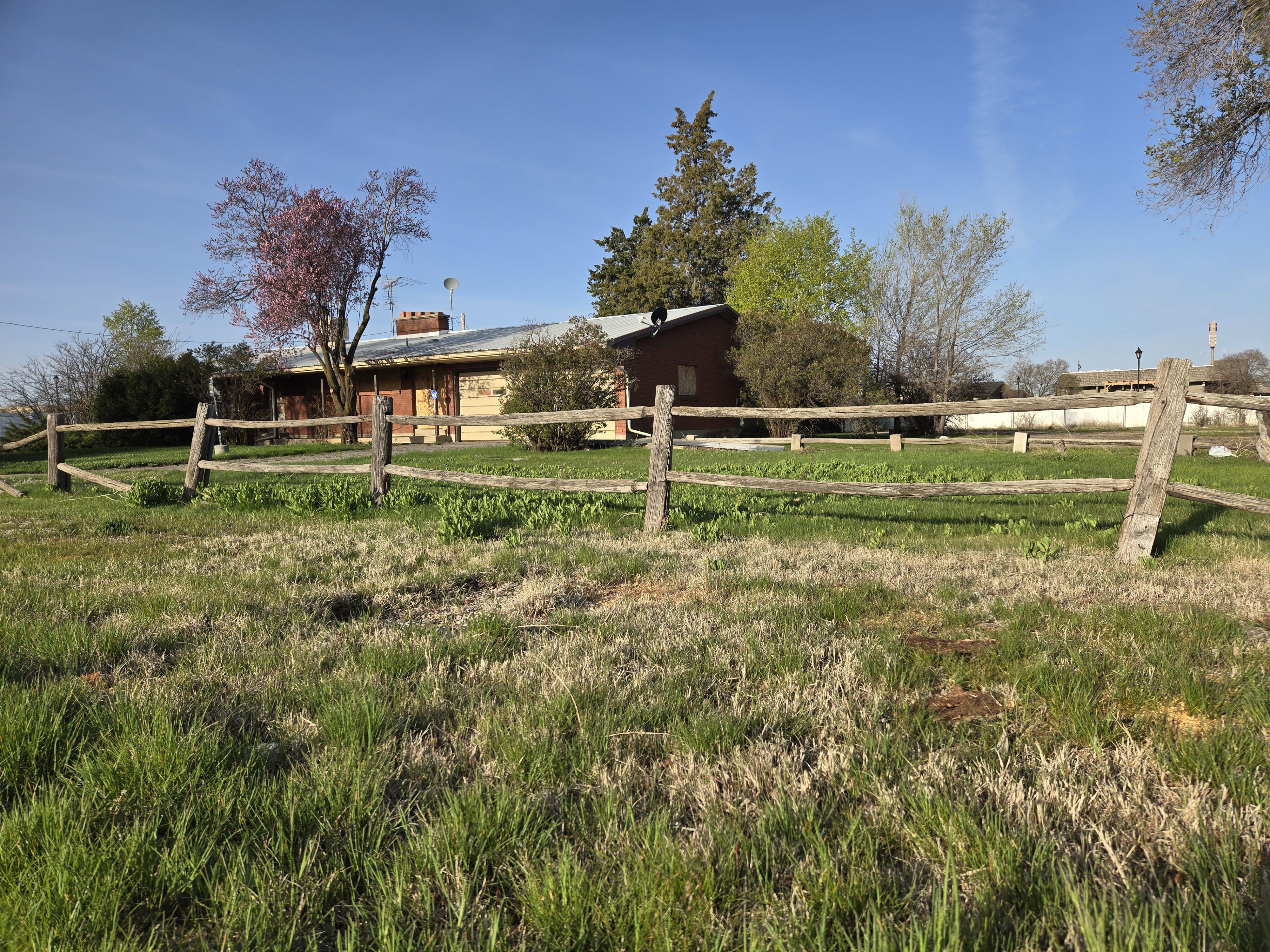 View of yard with a rural view and fence