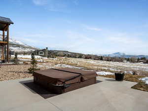 Snow covered patio featuring stairway and a mountain view