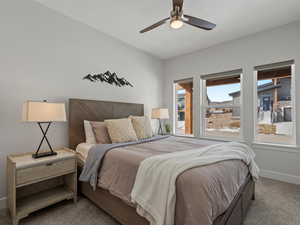 Bedroom with ceiling fan, carpet, and baseboards