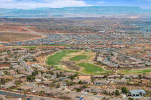 Aerial view featuring a residential view, view of golf course, and a mountain view