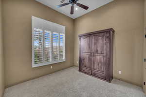 Unfurnished bedroom featuring carpet floors, visible vents, baseboards, and a ceiling fan