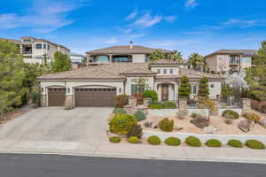 Mediterranean / spanish house with an attached garage, fence, concrete driveway, a tiled roof, and stucco siding