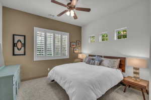 Bedroom with multiple windows, carpet, visible vents, and baseboards