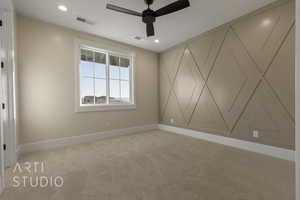 Empty room featuring light carpet, baseboards, visible vents, and recessed lighting