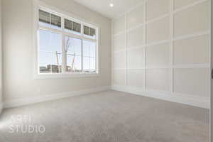 Unfurnished room with a decorative wall, recessed lighting, carpet flooring, and baseboards