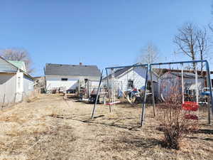 View of yard with an outbuilding, fence, and a storage shed