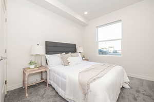 Carpeted bedroom with baseboards and recessed lighting