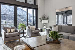 Living area with a high ceiling and a mountain view